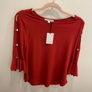 New burnt orange blouse with cropped sleeves.